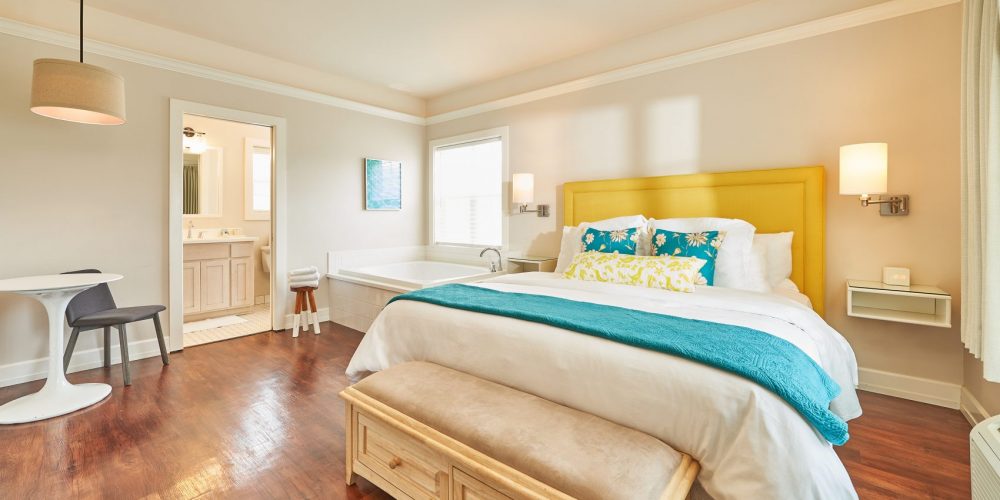 A cozy one room studio features a pillow top King bed, a two-person soaking tub fed with mineral spring water in the living room, fireplace, flat screen TV, mini-fridge, and more. View Details
